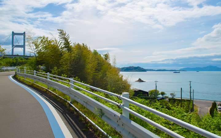 Scenic view of the Shimanami Kaidō cycling route connecting Japan’s Honshu and Shikoku islands, with bridges spanning the Seto Inland Sea and picturesque island landscapes