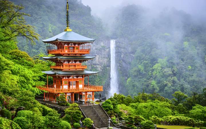 Seiganto-ji Temple with Nachi Falls in Wakayama, Japan – a stunning UNESCO World Heritage site where a historic pagoda stands beside Japan’s tallest waterfall amid lush forest scenery