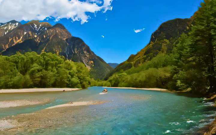 Scenic view inside Kamikōchi Wetlands in the Japanese Alps, featuring crystal-clear streams, lush marshland, and dramatic mountain backdrops in Chubu Sangaku National Park.
