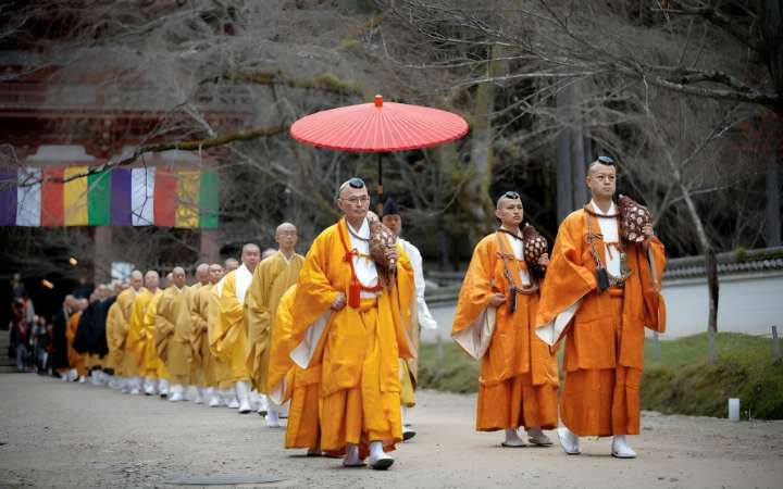 Buddhist monk walking peacefully in Mount Koya (Koyasan), Japan, a sacred pilgrimage site known for its temples, spiritual retreats, and serene mountain atmosphere