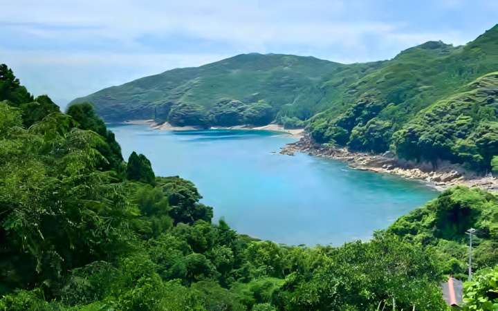Scenic view from Kumano Kodo Iseji trail to Hadasu, ancient pilgrimage path in Mie Japan with coastal landscapes, mountains, and traditional village scenery