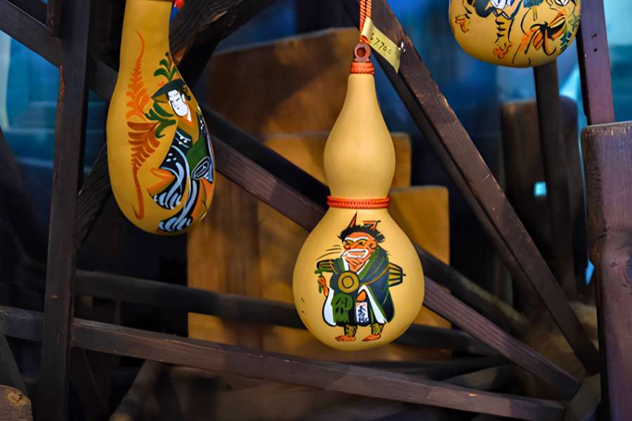 Traditional hand-painted gourds displaying Japanese figures, discovered during a 5-day self-guided walking tour from Lake Biwa to Kyoto through historic Shiga prefecture.