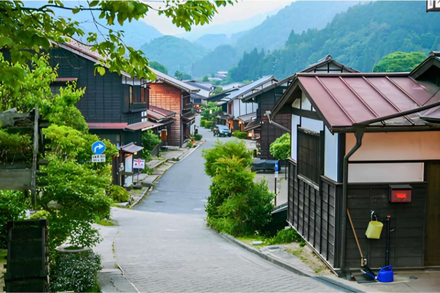 Traditional wooden buildings line the stone-paved streets of Magome-juku, a beautifully preserved Edo-period post town on Japan’s historic Nakasendō Trail in Gifu Prefecture.