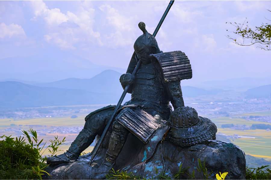 Samurai statue overlooking the Ōmi Plain near the Kannonshōji Castle ruins on the Lake Biwa: Storied Trails of Shiga 3-day self-guided walking tour in Shiga, Japan.
